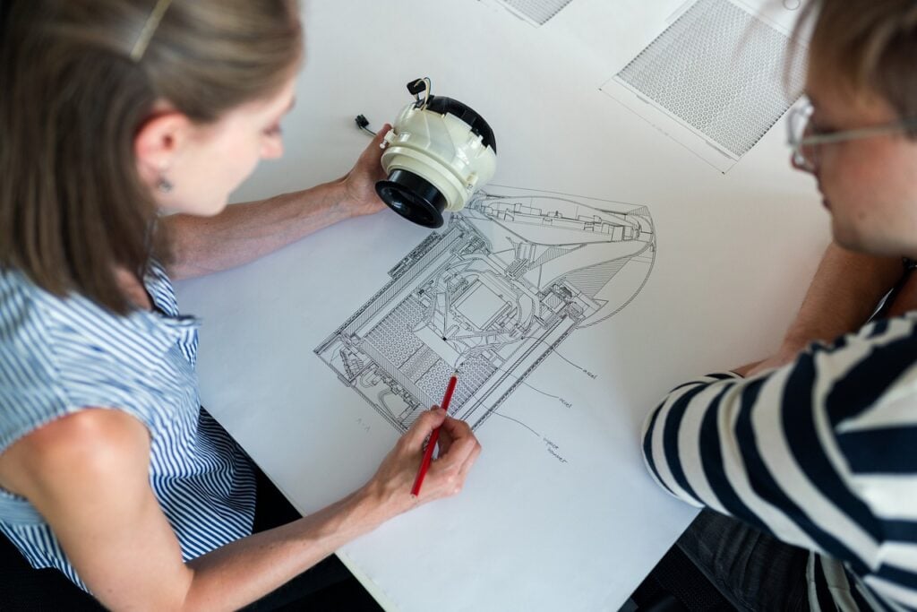 architects discussing blueprints over table