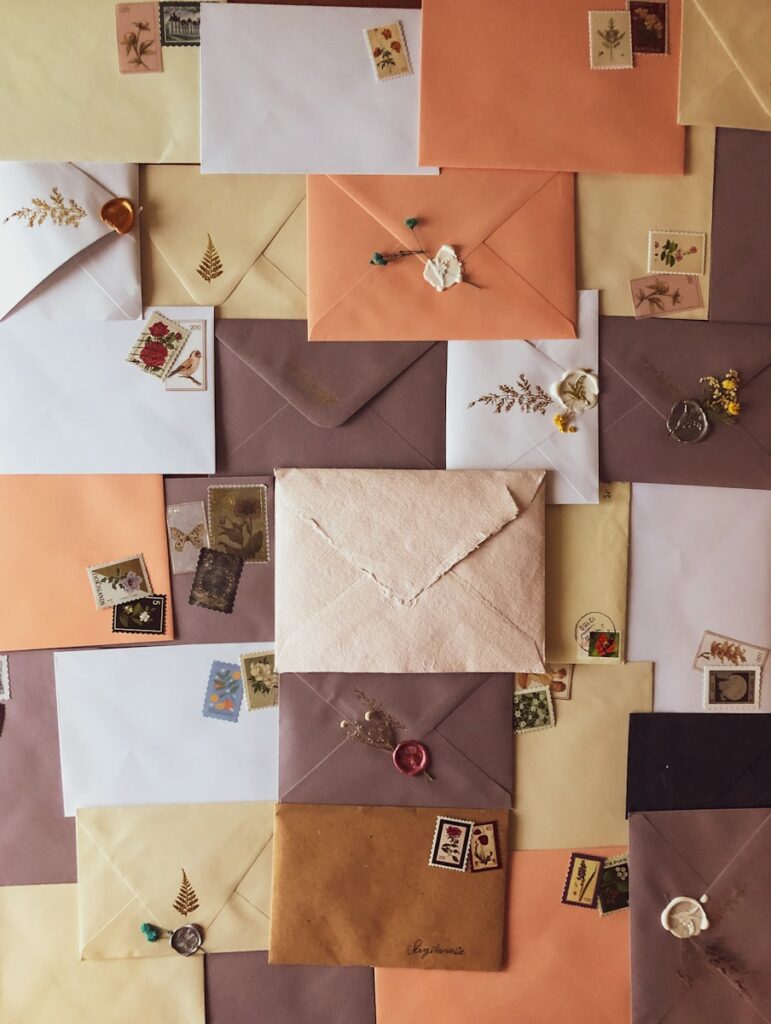a bunch of neatly arranged envelopes in warm colors